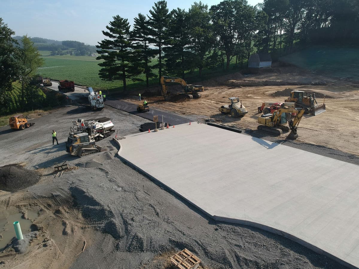 Crew laying concrete slab